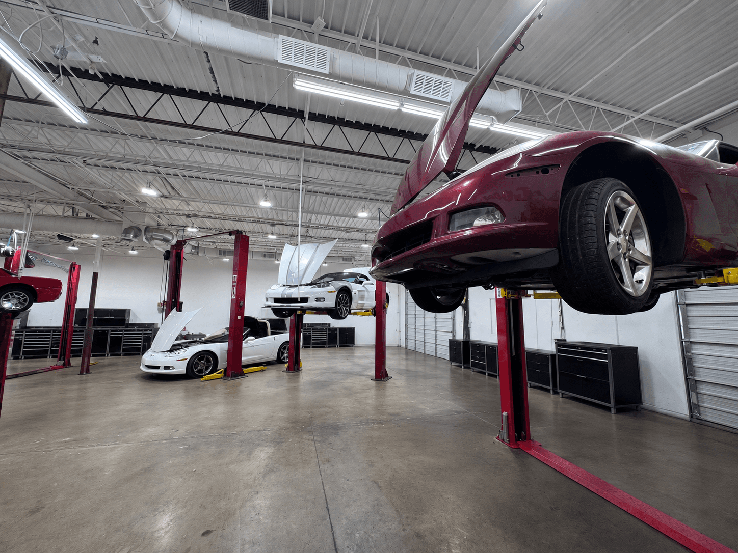 Service bays and vehicle lifts inside Corvette Warehouse Service Center